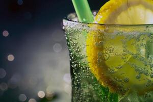 Refreshing glass of lemonade, condensation glistening in the summer heat photo