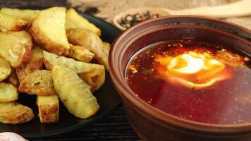 Ukrainian borscht with sour cream and fried potatoes. Ukrainian food. video