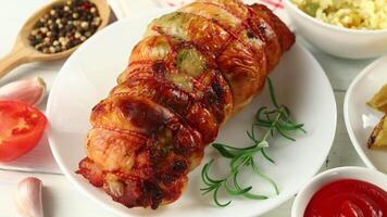 boneless meat roulade with seasonings and garnish. Meat roll close-up. video