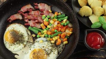 Fried eggs with vegetables in a pan. video