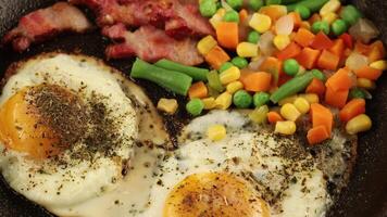 Fried eggs with vegetables in a pan. video
