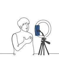 man broadcasts while standing in front of a phone camera mounted on a ring lamp - one line art . concept live stream of male blogger vector