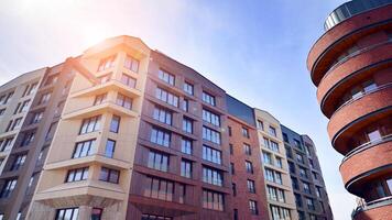 Contemporary residential building exterior in the daylight. Modern apartment buildings on a sunny day with a blue sky. Facade of a modern apartment building photo