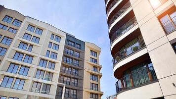 Contemporary residential building exterior in the daylight. Modern apartment buildings on a sunny day with a blue sky. Facade of a modern apartment building photo