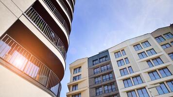 Contemporary residential building exterior in the daylight. Modern apartment buildings on a sunny day with a blue sky. Facade of a modern apartment building photo