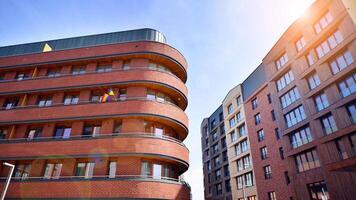 Contemporary residential building exterior in the daylight. Modern apartment buildings on a sunny day with a blue sky. Facade of a modern apartment building photo