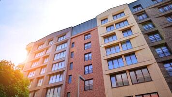 Modern residential building with new apartments in a green residential area. Eco architecture. Green tree and new apartment building. The harmony of nature and modernity. photo