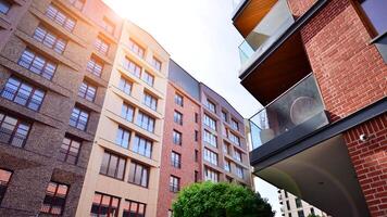 Modern residential building with new apartments in a green residential area. Eco architecture. Green tree and new apartment building. The harmony of nature and modernity. photo