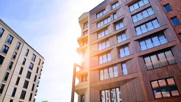 Contemporary residential building exterior in the daylight. Modern apartment buildings on a sunny day with a blue sky. Facade of a modern apartment building photo