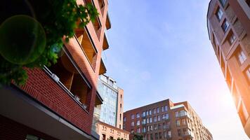 Modern residential building with new apartments in a green residential area. Eco architecture. Green tree and new apartment building. The harmony of nature and modernity. photo