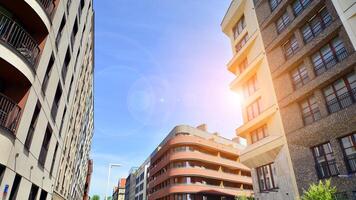 Contemporary residential building exterior in the daylight. Modern apartment buildings on a sunny day with a blue sky. Facade of a modern apartment building photo