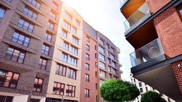 Modern residential building with new apartments in a green residential area. Eco architecture. Green tree and new apartment building. The harmony of nature and modernity. photo