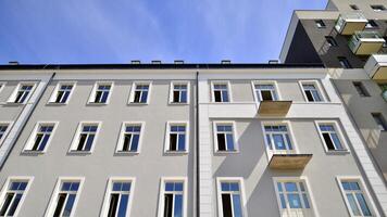 Contemporary residential building exterior in the daylight. Modern apartment buildings on a sunny day with a blue sky. Facade of a modern apartment building photo