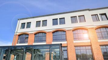 Modern office building with white metallic panel facade and windows. Modern architectural details. photo