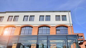 Modern office building with white metallic panel facade and windows. Modern architectural details. photo