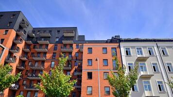 Modern residential building with new apartments in a green residential area. Eco architecture. Green tree and new apartment building. The harmony of nature and modernity. photo