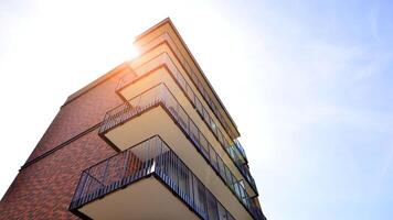 Contemporary residential building exterior in the daylight. Modern apartment buildings on a sunny day with a blue sky. Facade of a modern apartment building photo