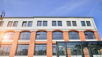 Modern office building with white metallic panel facade and windows. Modern architectural details. photo