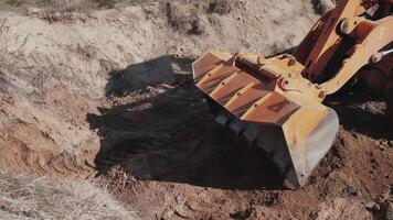 A tractor digs a hole at a construction site 4k video