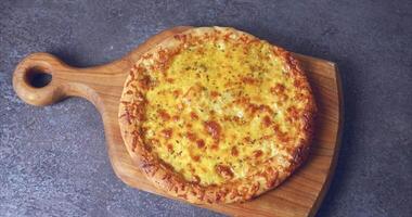 Oven baked pizza with cheese and spices on a wooden board video