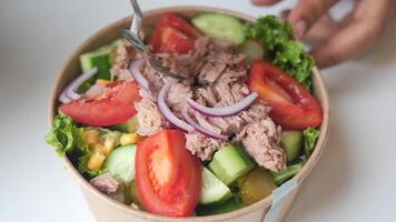 spoon pick tuna salad from a bowl on table video