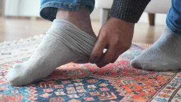 Close-up of man hands putting a socks on his feet video