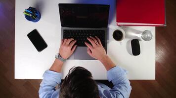 top view time lapse a man works at a computer in the office and drinks coffee video