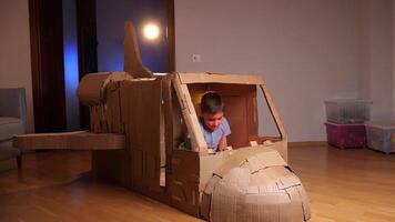 The boy dreams of becoming an astronaut. boy built a spaceship out of cardboard video