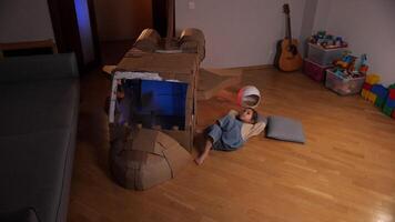 little girl plays pilot, astronaut, lies on the floor and thinks, dreams video