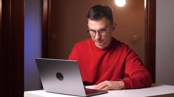 agree gesture Young programmer freelancer man works on laptop and nodding. video