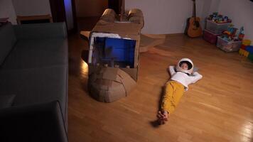 a boy in an astronaut's helmet dreams of flying into space. Dreamer concept video