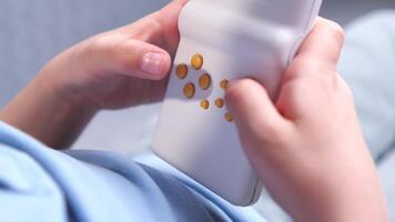 close-up of a boy playing an old vintage handheld console in white color video