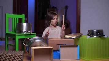 little girl plays pot drums at home, girl drums and has fun in her room video