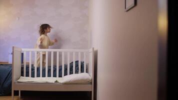 little girl jumping on the bed, girl doesn't want to sleep, disobedient child video