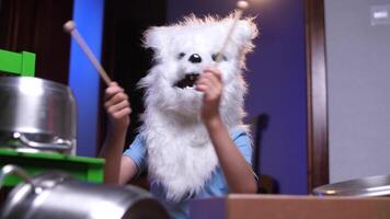 boy child in dog wolf costume for halloween plays drums, halloween prank video