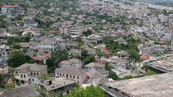Fortress in Gjirokastra a huge stone building on a high mountain in Albania with a clock the history of the Middle Ages a beautiful view from the stone city to the ancient village video