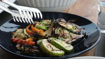 Eggplant zucchini carrots Grilled vegetables on a black plate, tasty and appetizing presentation video