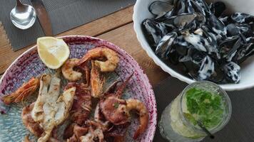 Seafood on a plate mussels in sweet and sour sauce in creamy mojito sauce video