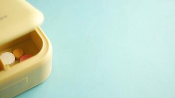 close up of medical pills in a pill box on table video