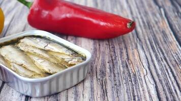 open tin of sardines on white tiles background. video