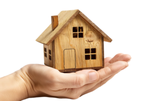 Hand holding a small simple house on isolated transparent background png