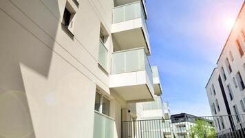 Contemporary residential building exterior in the daylight. Modern apartment buildings on a sunny day with a blue sky. Facade of a modern apartment building photo