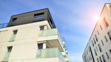 Contemporary residential building exterior in the daylight. Modern apartment buildings on a sunny day with a blue sky. Facade of a modern apartment building photo