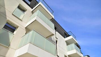 Contemporary residential building exterior in the daylight. Modern apartment buildings on a sunny day with a blue sky. Facade of a modern apartment building photo