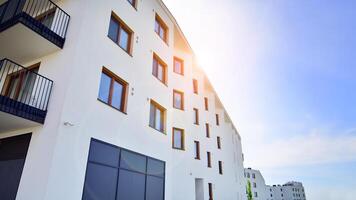 Contemporary residential building exterior in the daylight. Modern apartment buildings on a sunny day with a blue sky. Facade of a modern apartment building photo