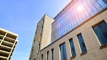 Modern office building detail. Perspective view of geometric angular concrete windows on the facade of a modernist brutalist style building. photo