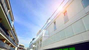 Contemporary residential building exterior in the daylight. Modern apartment buildings on a sunny day with a blue sky. Facade of a modern apartment building photo