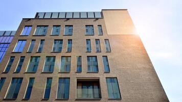 Modern office building detail. Perspective view of geometric angular concrete windows on the facade of a modernist brutalist style building. photo