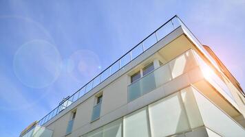 Contemporary residential building exterior in the daylight. Modern apartment buildings on a sunny day with a blue sky. Facade of a modern apartment building photo