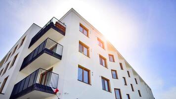 Contemporary residential building exterior in the daylight. Modern apartment buildings on a sunny day with a blue sky. Facade of a modern apartment building photo